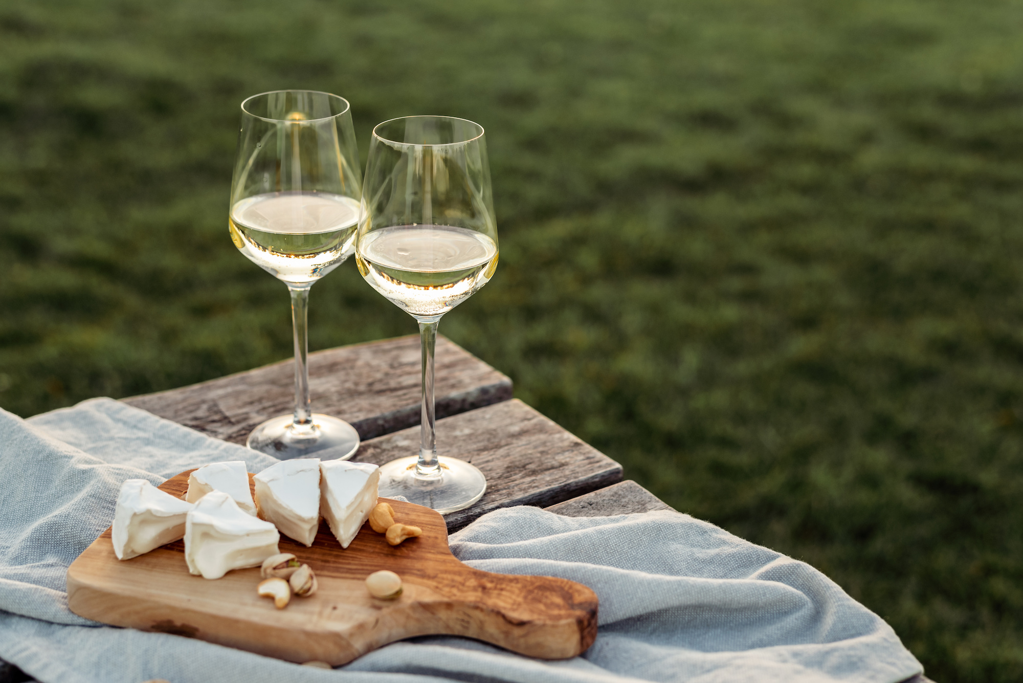 The Claiborne at Thibodaux restaurant-style dining, two wine glasses and cheese board