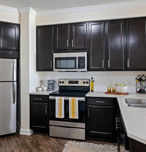 The Claiborne at Baton Rouge senior apartment full kitchen with stainless steel appliances and high-end finishes
