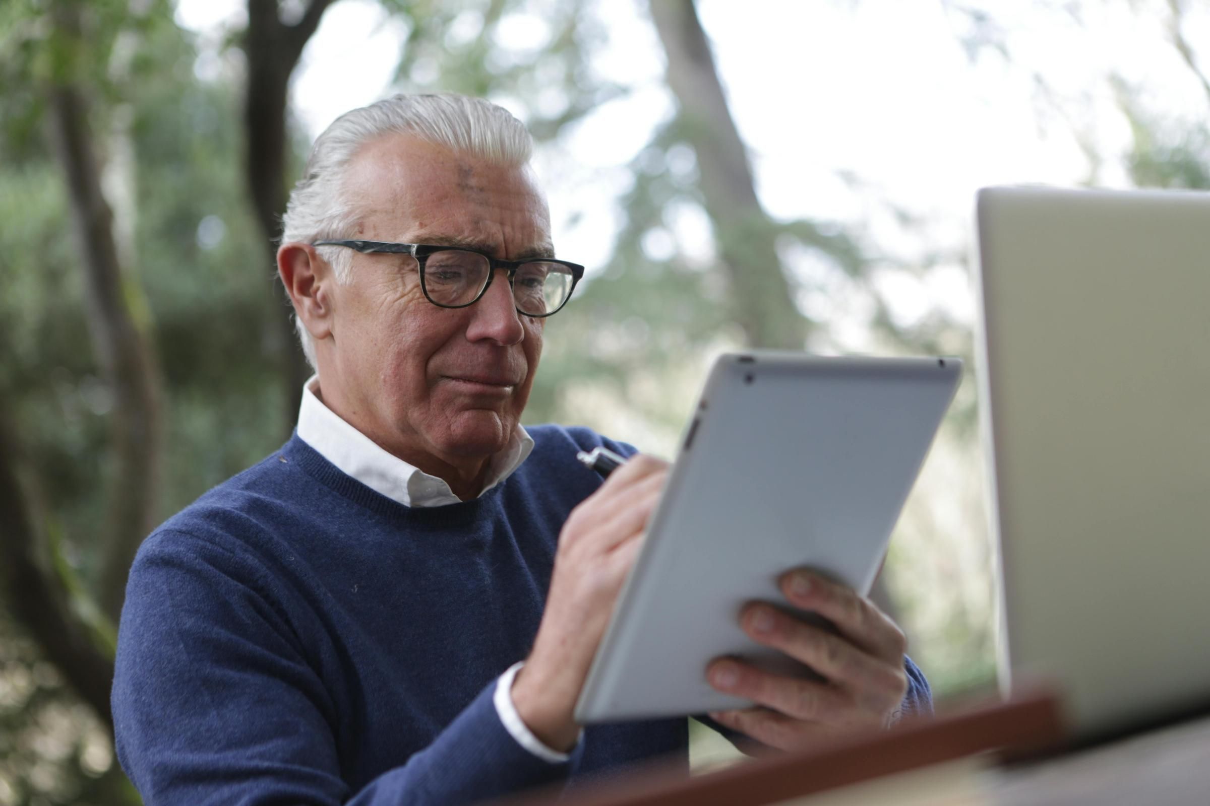 Senior man looking at iPad.