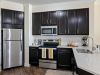 The Claiborne at Baton Rouge senior apartment full kitchen with high-end design and appliances