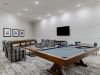 The Claiborne at Baton Rouge game room with tables and chairs