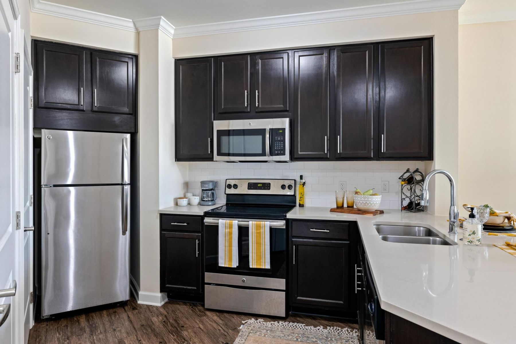 The Claiborne at Baton Rouge senior apartment with full kitchen showing kitchen island and stainless steel appliances