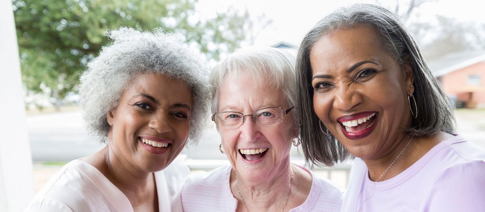 Three senior girlfriends smiling together