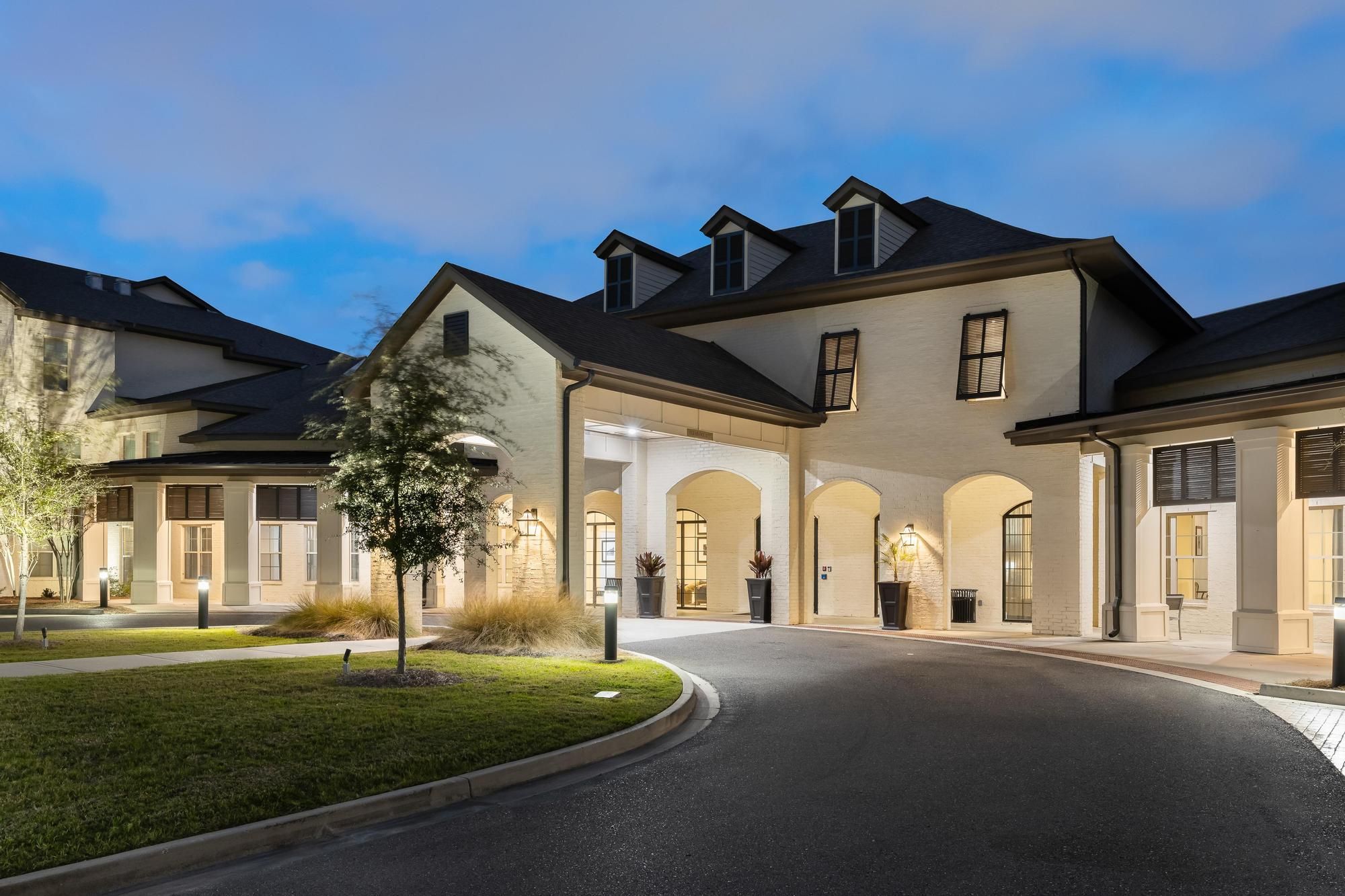 The Claiborne at Baton Rouge senior community exterior view, lit up at night