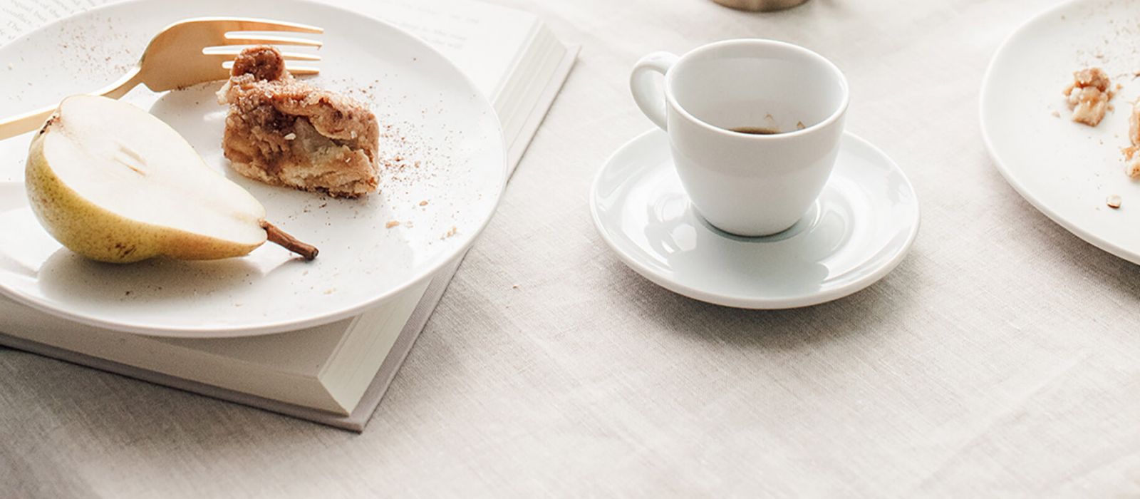 Coffee and pastry treats at white and bright table.