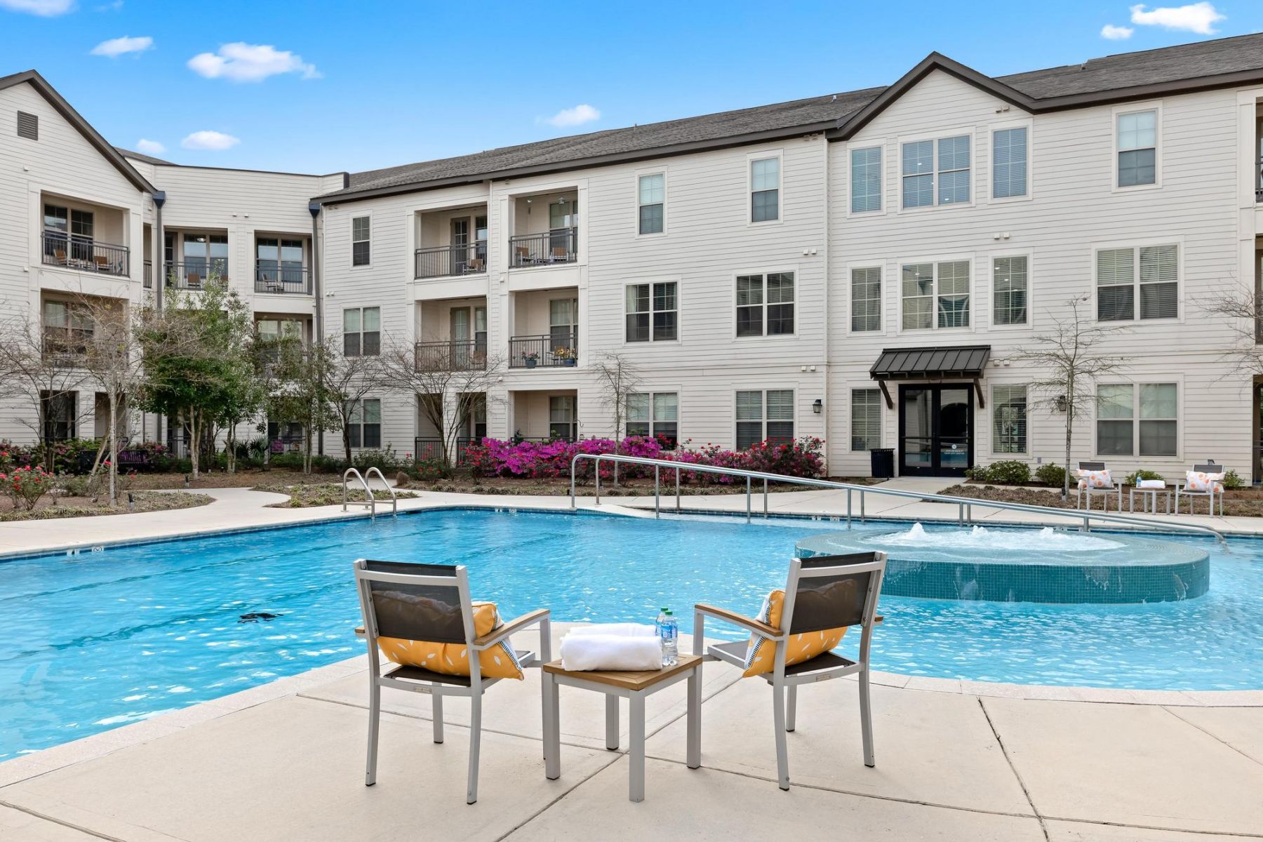 The Claiborne at Baton Rouge senior apartment with full kitchen showing kitchen island and stainless steel appliances