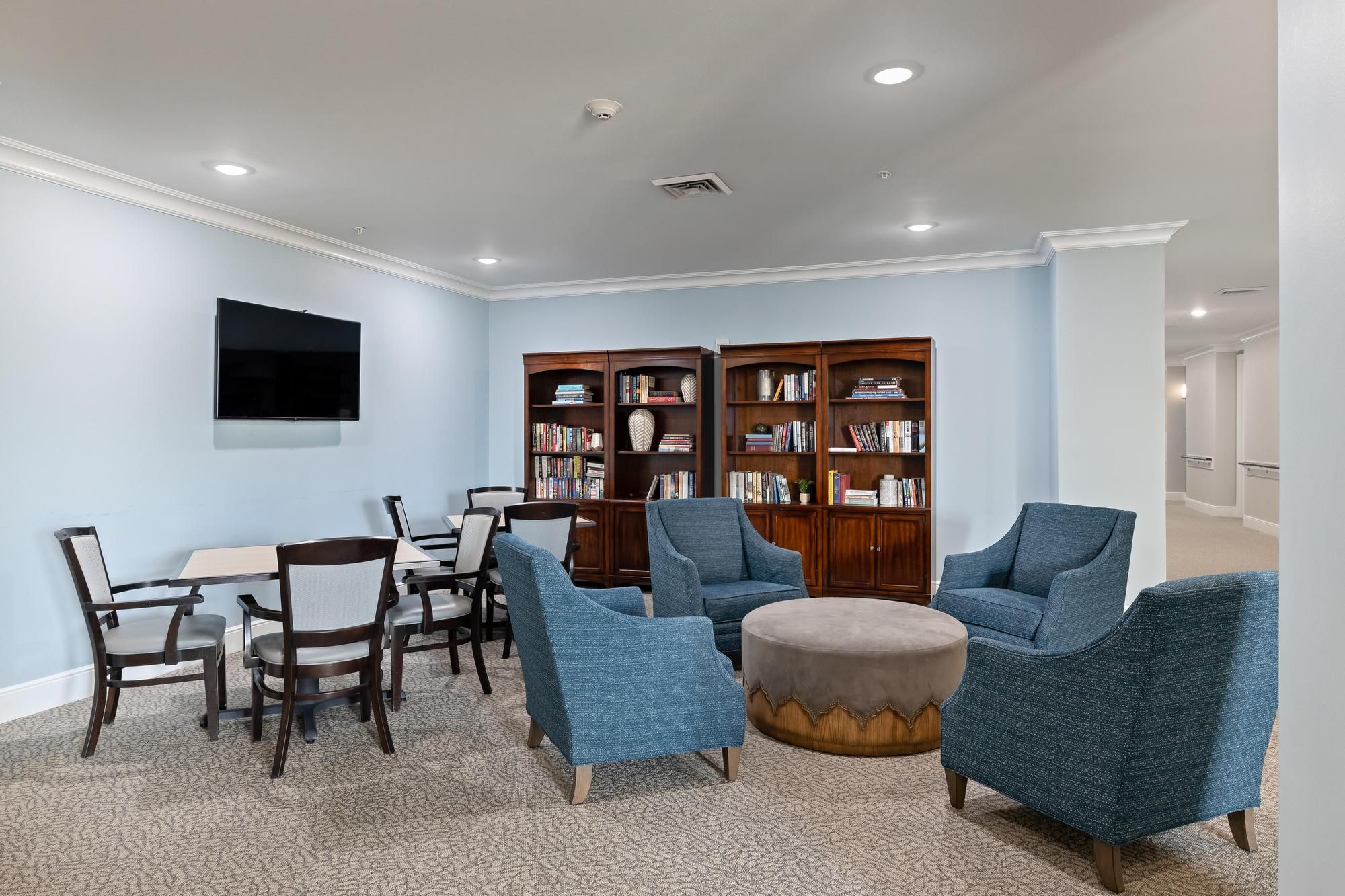 The Claiborne at Baton Rouge senior community library with books and comfortable chairs