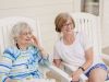 The Claiborne at Baton Rouge senior woman and daughter sitting in rocking chairs at a Claiborne community