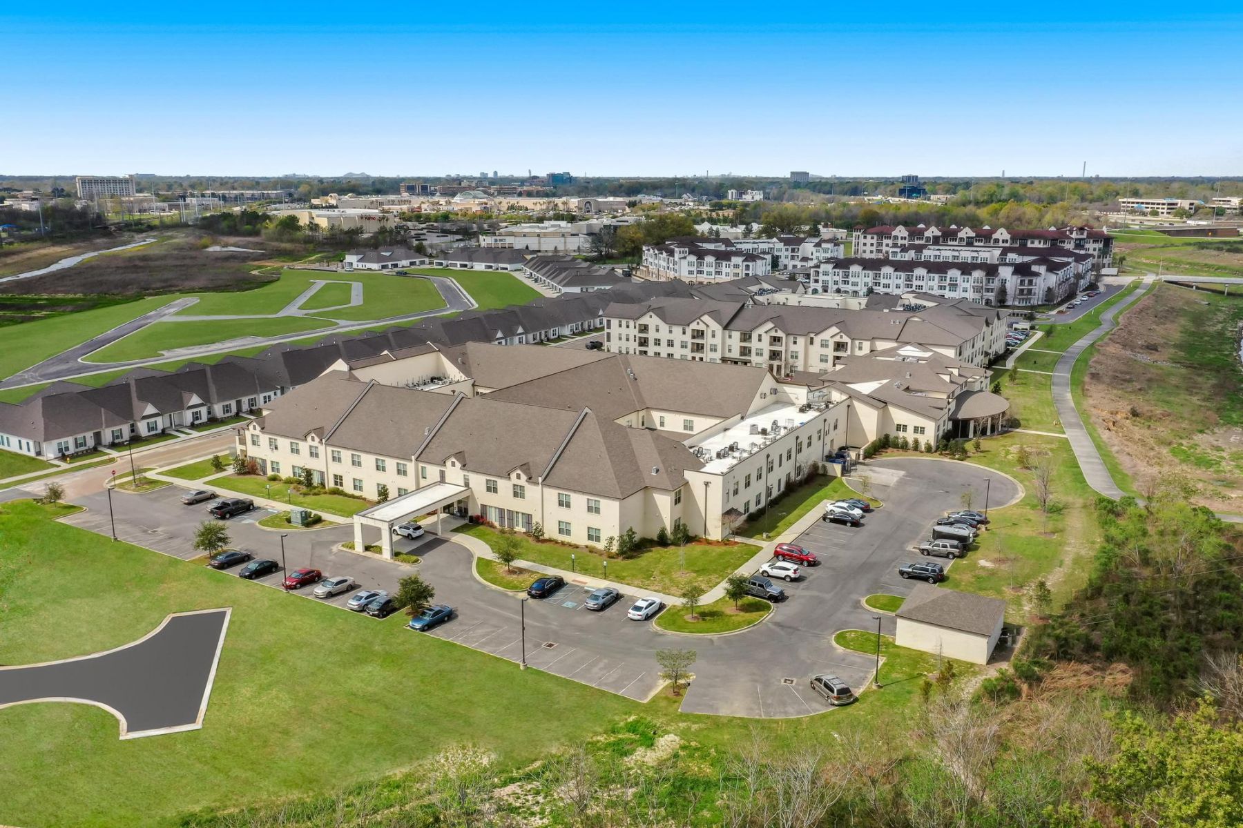 The Claiborne at Baton Rouge senior apartment with full kitchen showing kitchen island and stainless steel appliances