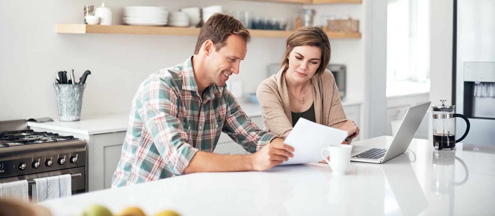 Man and woman sitting at white table making a plan