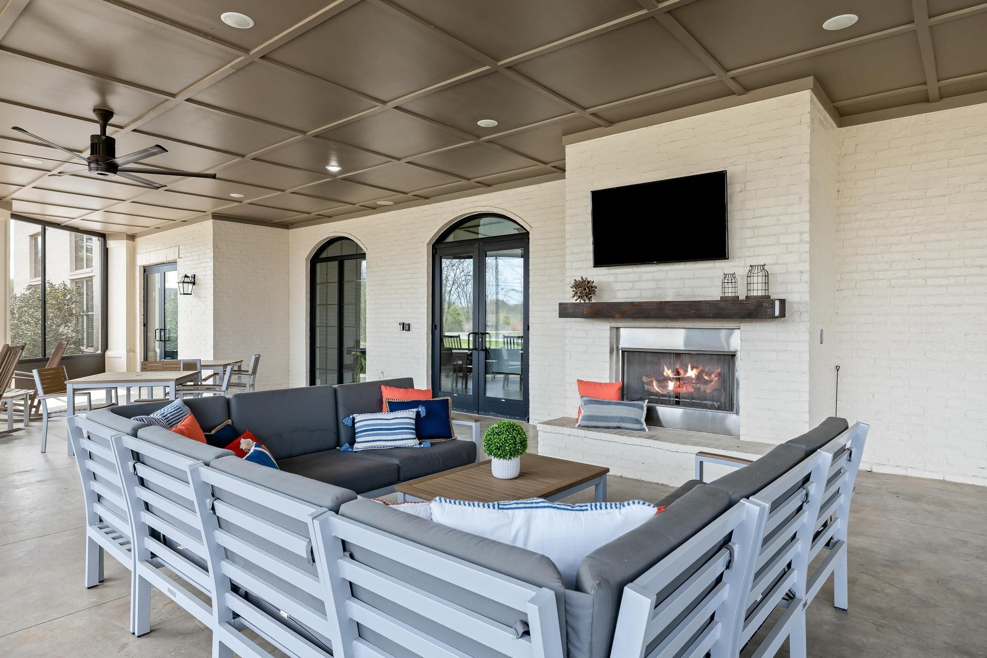 The Claiborne at Baton Rouge senior community outdoor patio with fireplace and lounge seating