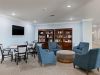 The Claiborne at Baton Rouge senior community library with books and comfortable chairs
