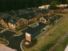 Brickmont at Acworth senior living community aerial view of assisted living community exterior and parking lot surrounded by forest