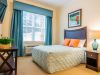 Brickmont at Acworth apartment bedroom with full sized bed, carpeting, and large windows