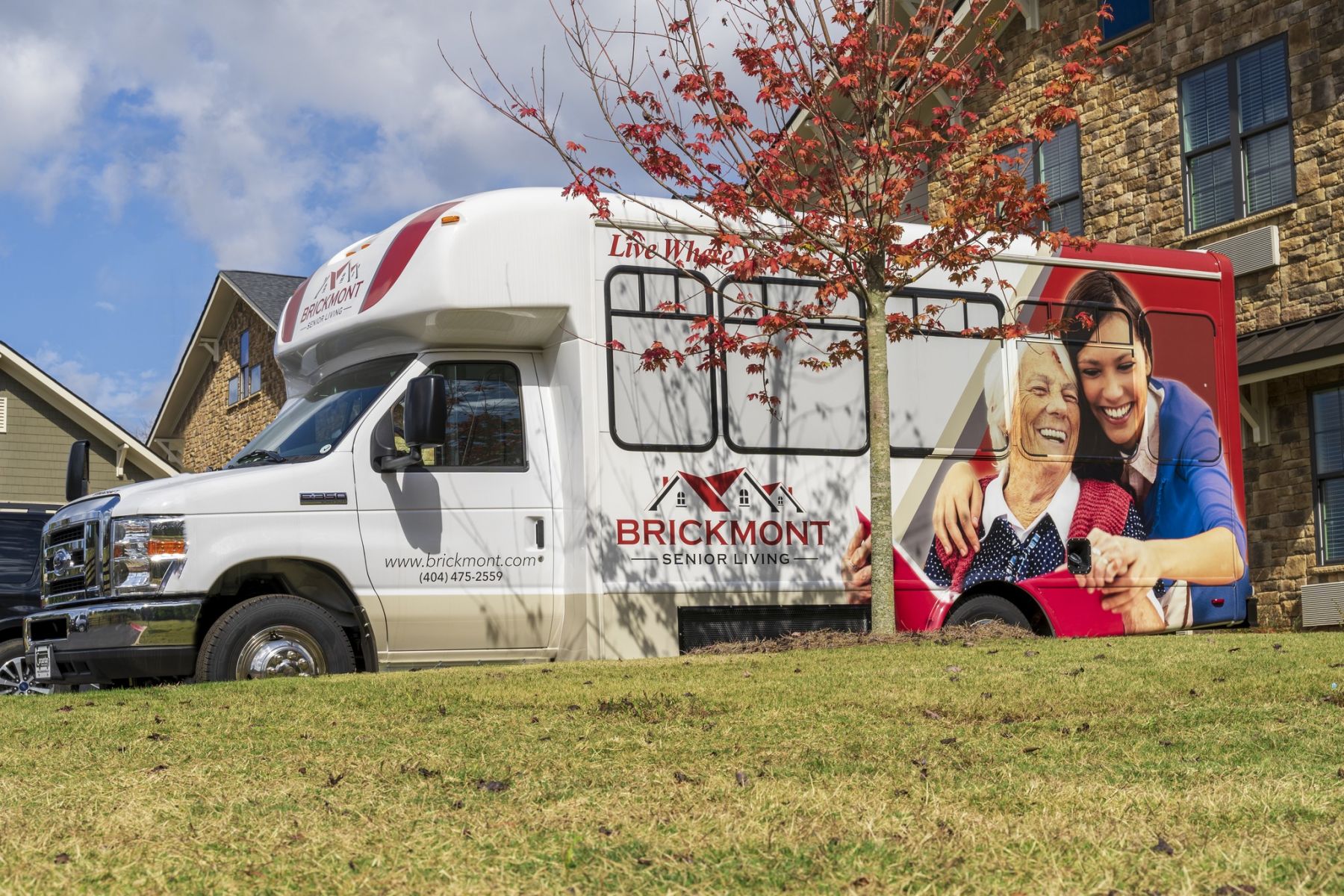 Brickmont at Johns Creek senior living community shuttle bus service parked outside the entrance