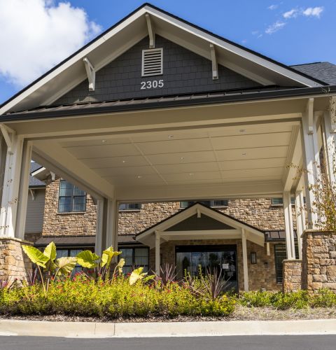 Brickmont at Johns Creek  senior living community outdoor exterior building covered entrance with landscaping