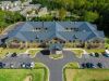 Brickmont at Johns Creek aerial view of assisted living community exterior and parking lot surrounded by forest