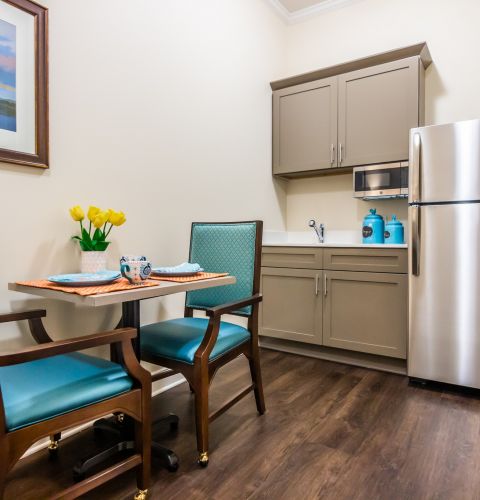 Brickmont at Johns Creek  apartment kitchenette with table and chairs, full sized fridge, and storage