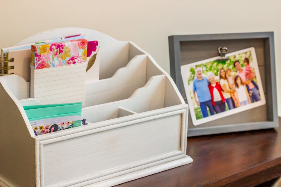 momentos organizer box and photos in a frame on a table