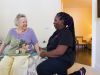 Brickmont at Johns Creek senior living community staff member assisting a resident in her apartment