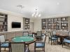 Brickmont at Roswell resident gaming lounge amenity with full kitchen, tables, chairs, games, and wall art