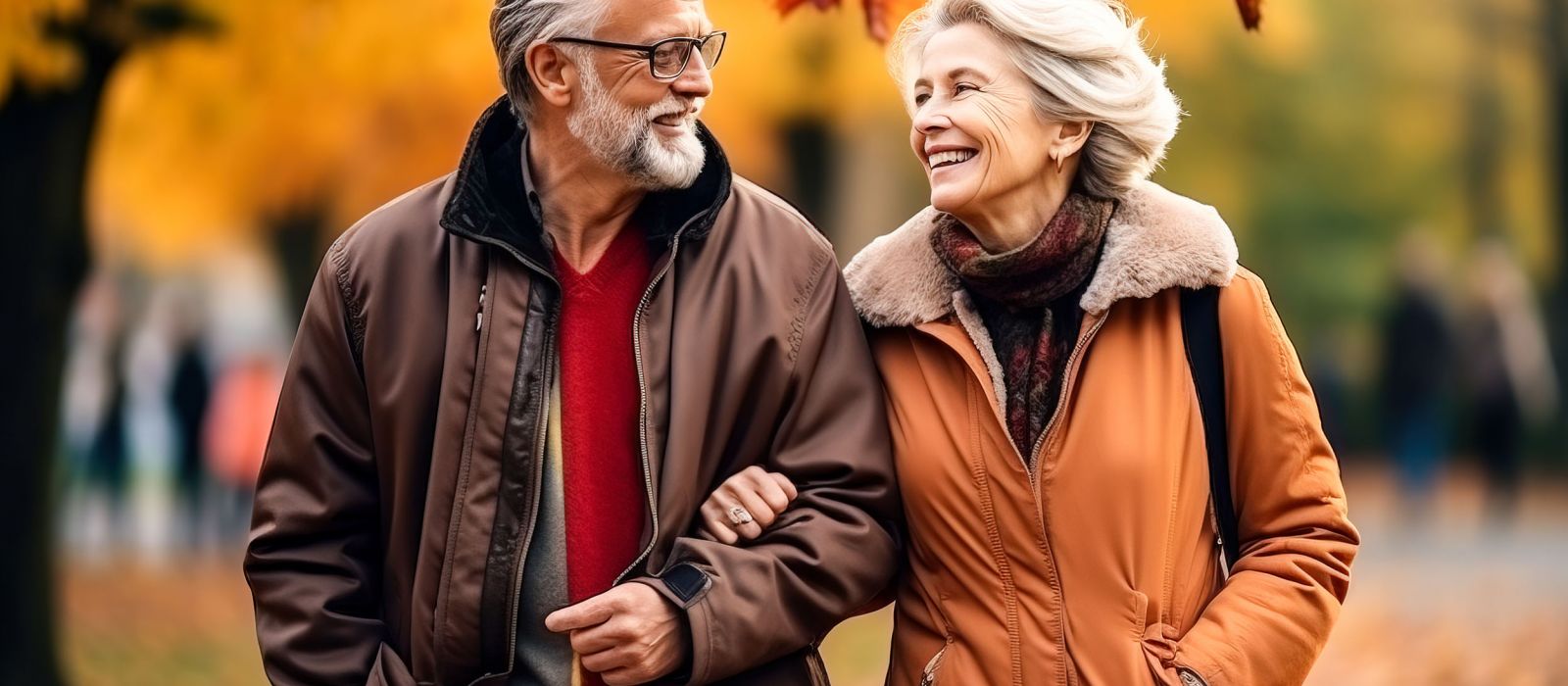 Beautiful elderly couple walking in an autumn park