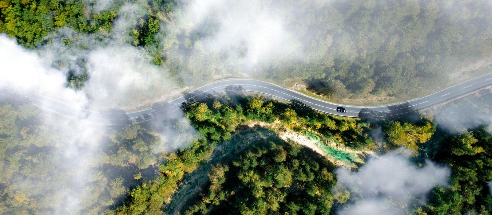 Car driving on the open road drone shot from above