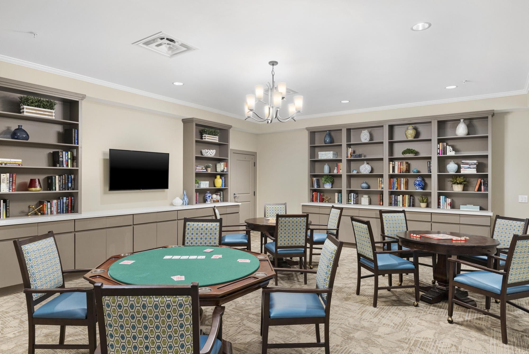 Brickmont at Roswell resident dining room amenity with tables and chairs, a stone fireplace, and grand piano