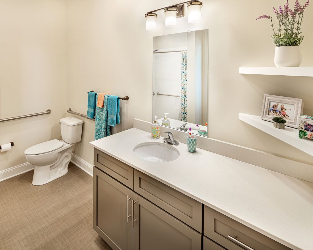 apartment bathroom with accessible toilet and ample storage