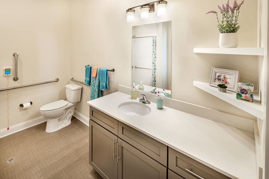 apartment bathroom with accessible toilet and ample storage