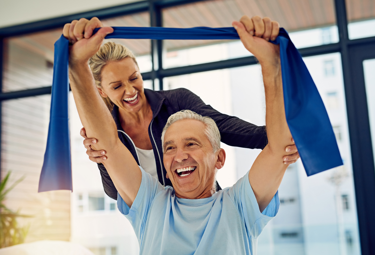 Senior man performing arm exercises with a physical therapist