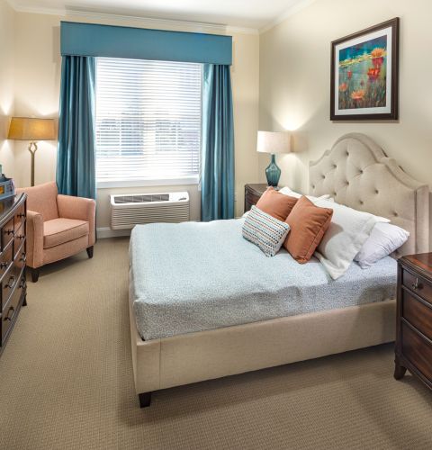 Brickmont at West Cobb apartment bedroom with full sized bed, carpeting, and sliding barn doors to main living space