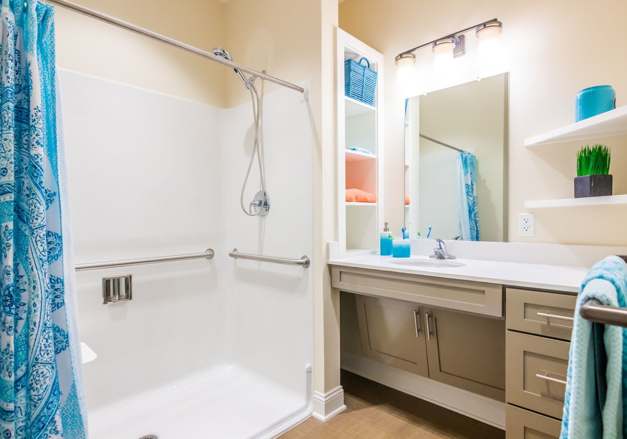 Brickmont at West Cobbapartment bathroom with walk-in shower, accessible sink, and ample storage