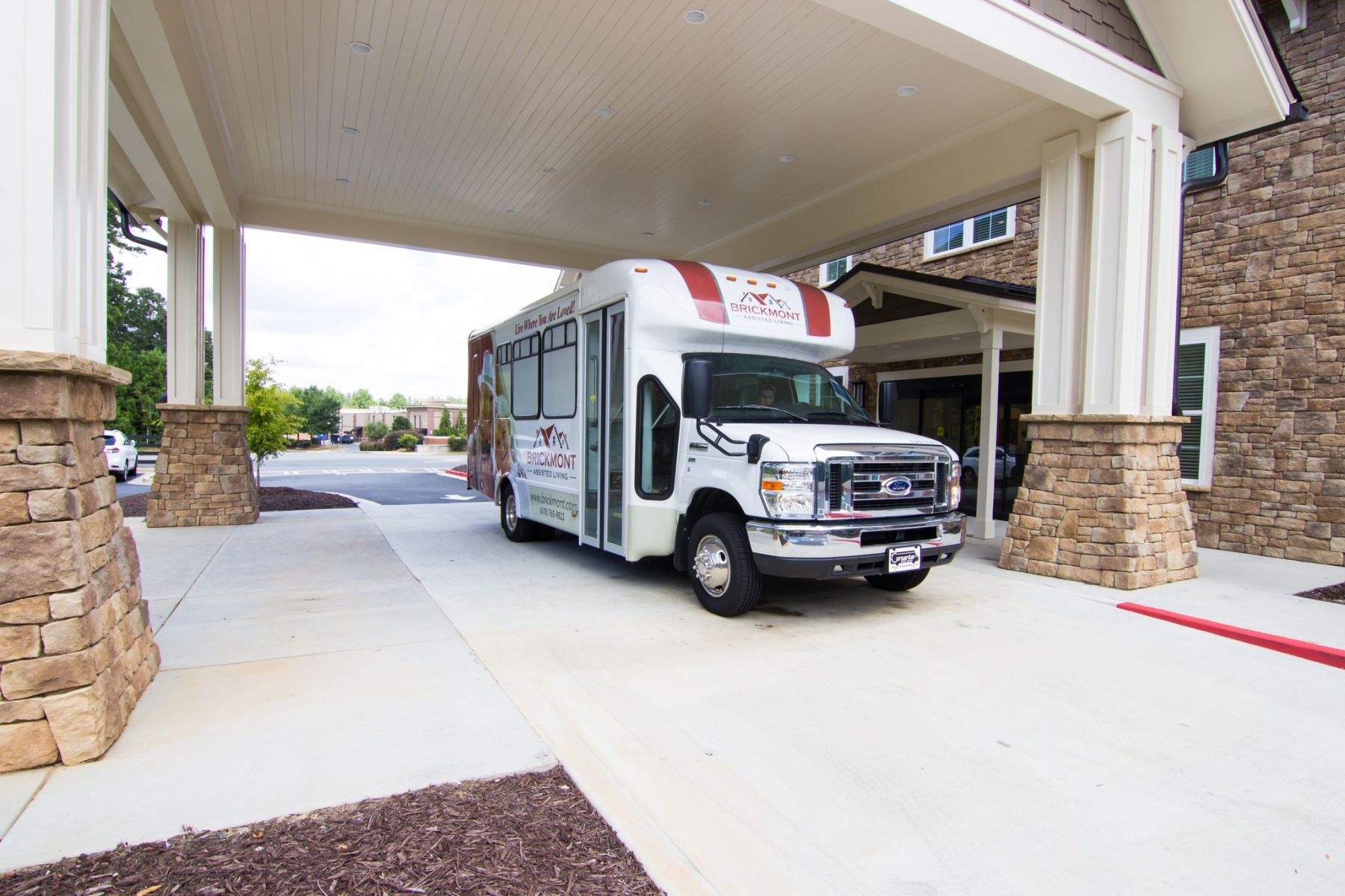 Brickmont at West Cobb senior living community shuttle bus service parked outside the entrance