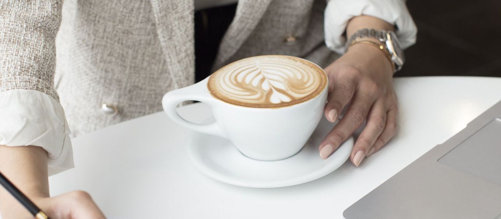 woman with a latte writing down a plan