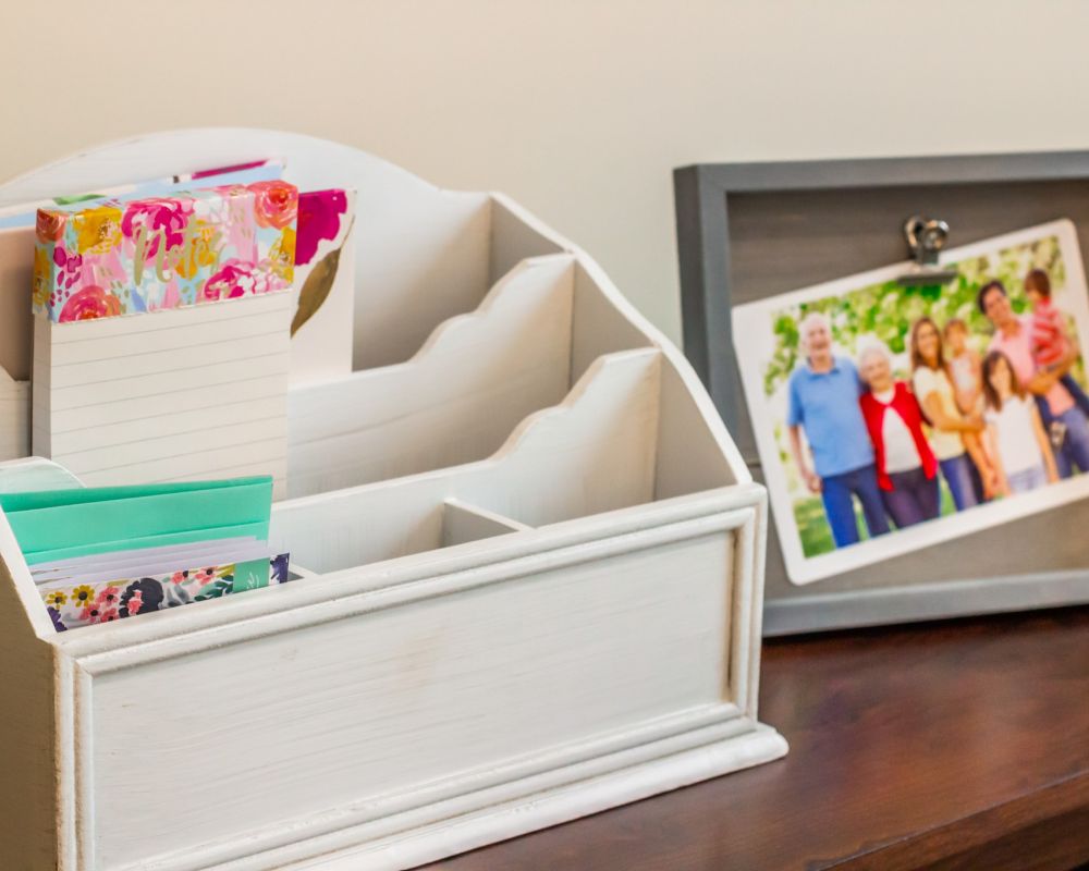 momentos organizer box and photos in a frame on a table