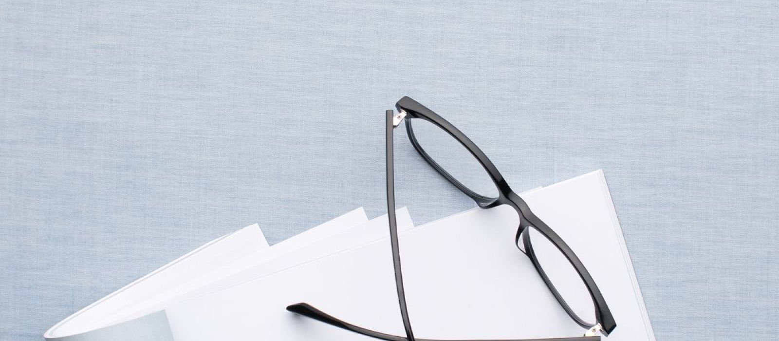 folded glasses on paper