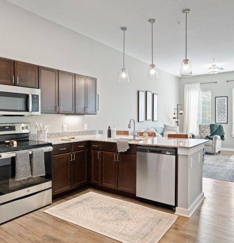 The Claiborne at Brickyard Crossing senior apartment full kitchen with stainless steel appliances and high-end finishes