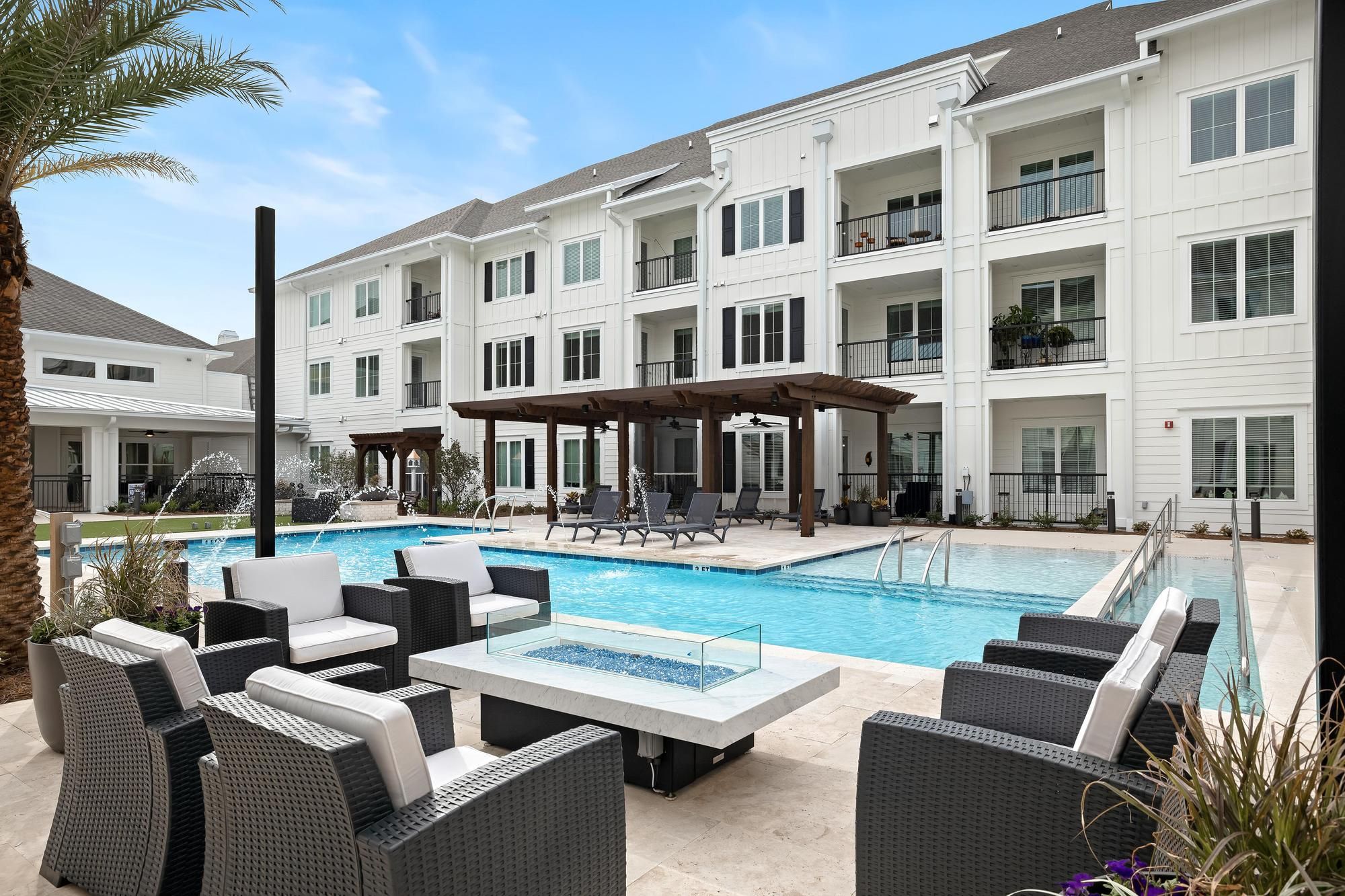 The Claiborne at Brickyard Crossing senior living community pool deck with zero-depth pool and seating