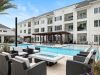 The Claiborne at Brickyard Crossing senior living community pool deck with zero-depth pool and seating