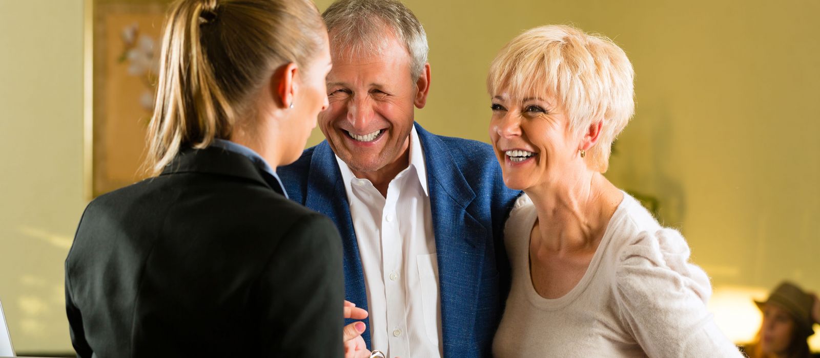 Elderly guests check in at a retirement home on a tour