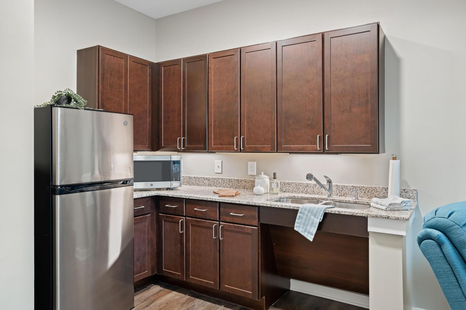 The Claiborne at Brickyard Crossing assisted living kitchenette showing accessibility features including sink and cabinet height