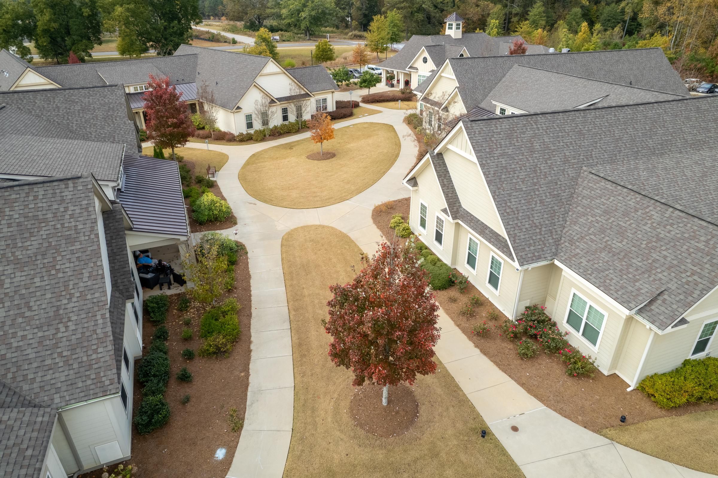 Camellia Place Camellia Place Aerial view of a residential complex with sidewalks, trees, and multiple cream-colored buildings.