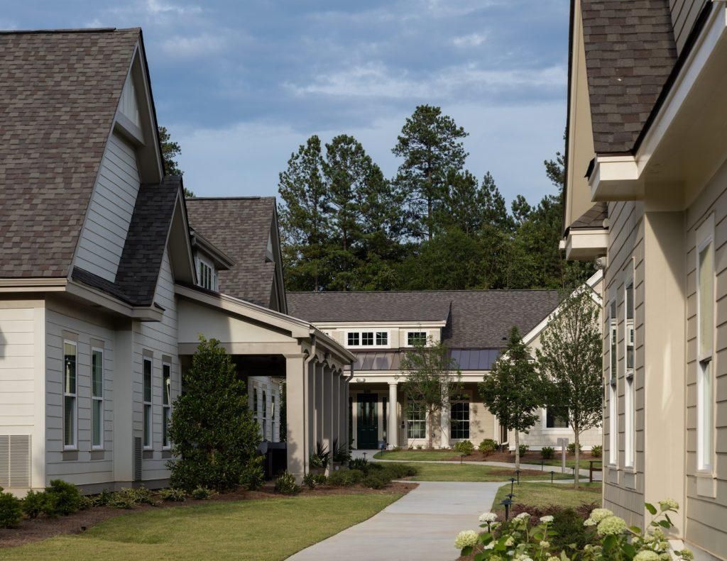 Camellia Place Pathway between modern suburban homes with manicured lawns and trees under a partly cloudy sky.