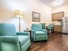 The Claiborne at Acworth upscale apartment kitchenette with quartz countertops, stainless steel appliances, and sitting area
