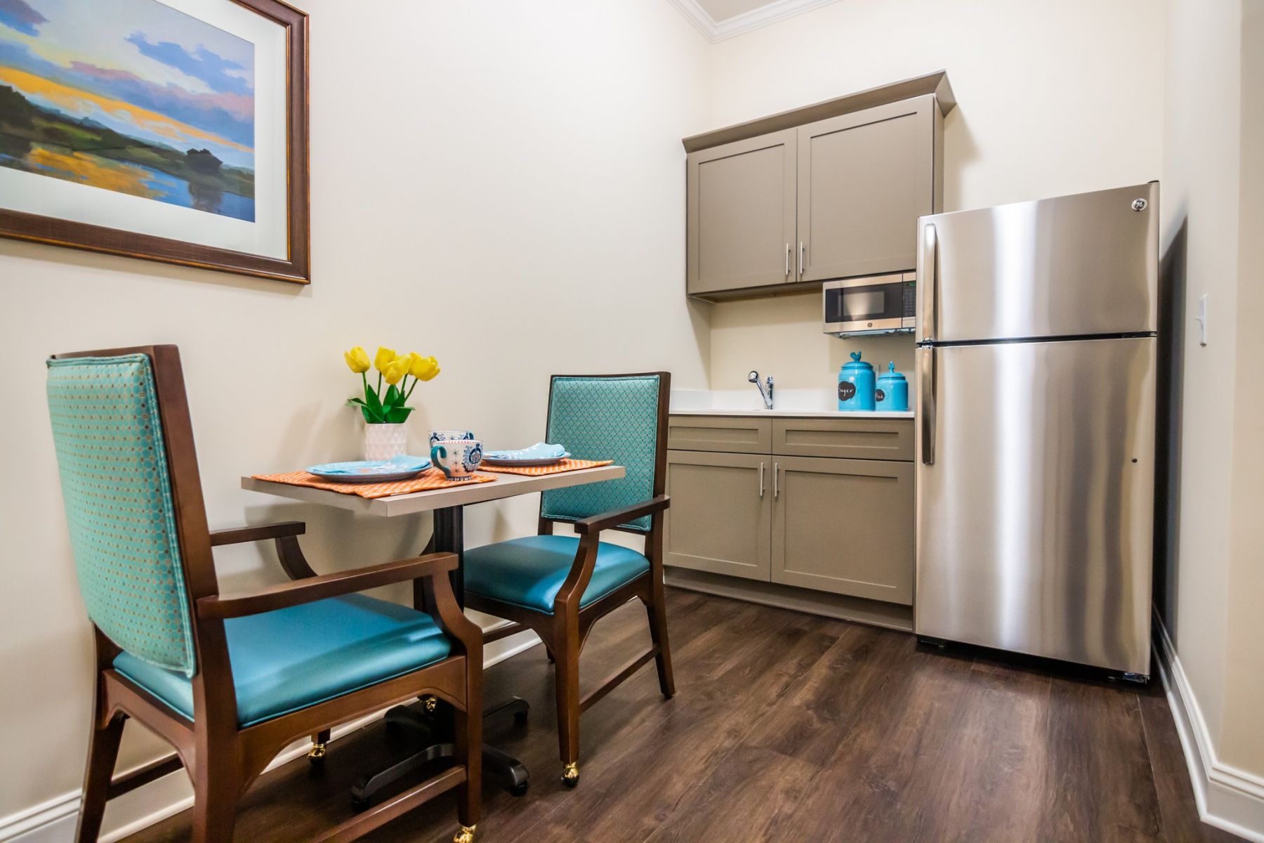  upscale apartment kitchenette with quartz countertops, stainless steel appliances, and dining areaThe Claiborne at Acworth