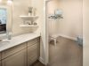 The Claiborne at Johns Creekapartment bathroom with large walk in closet attached