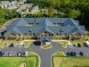The Claiborne at Johns Creek aerial view of assisted living community exterior and parking lot surrounded by forest