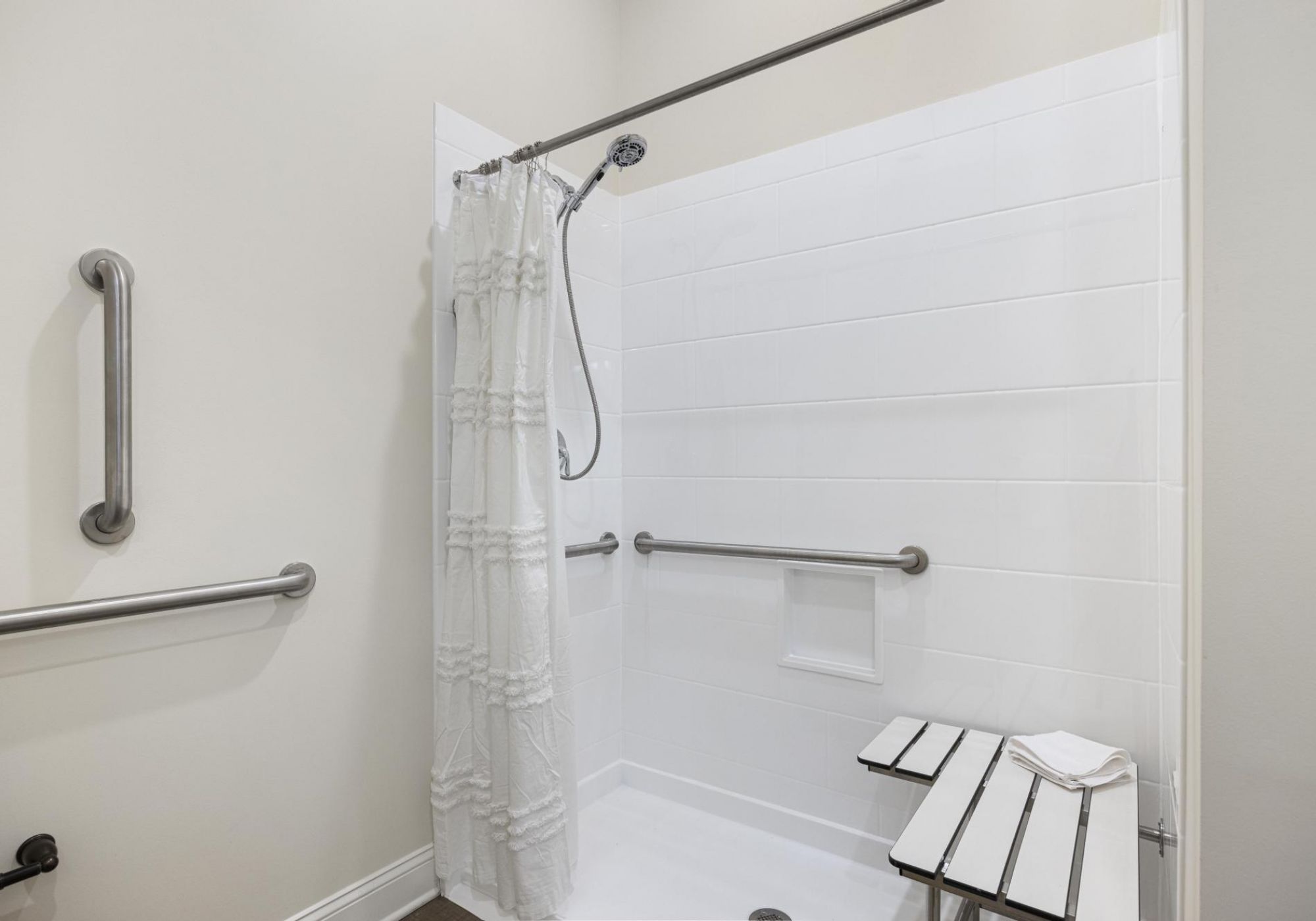 The Claiborne at Johns Creekapartment bathroom with walk-in shower, accessible sink, and ample storage