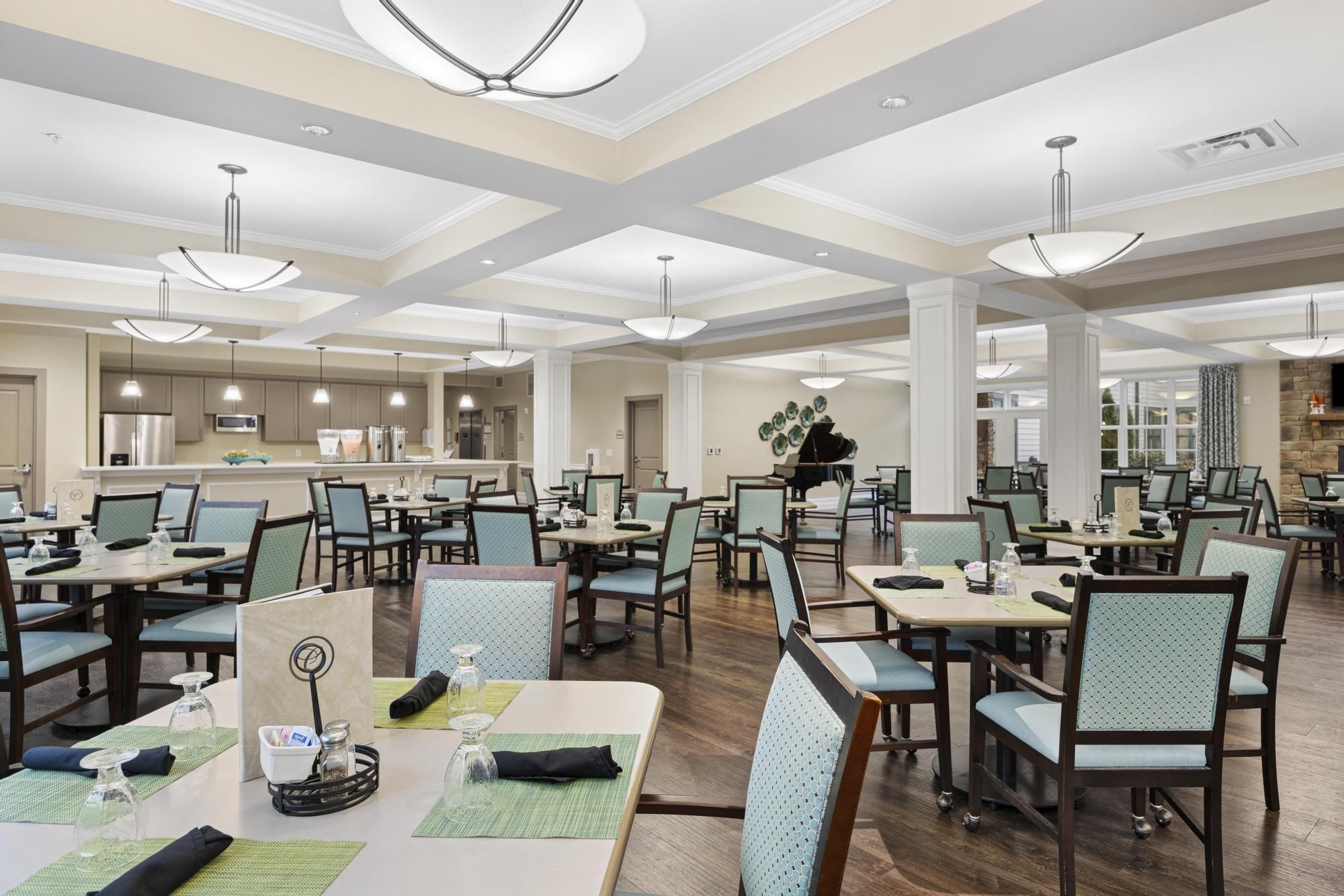 The Claiborne at Johns Creek senior living community amenity private dining room with dining table and chairs and upscale furnishings